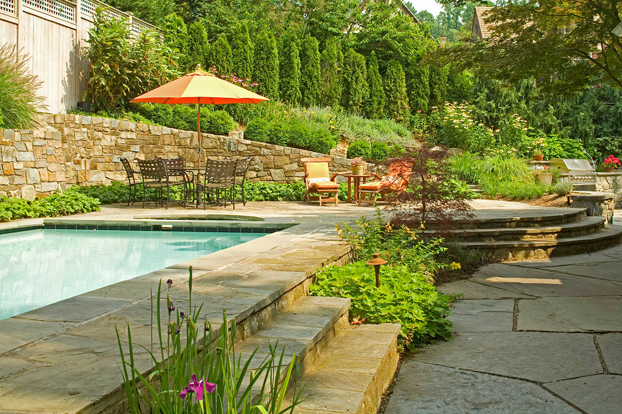 swimming pool built against retaining wall