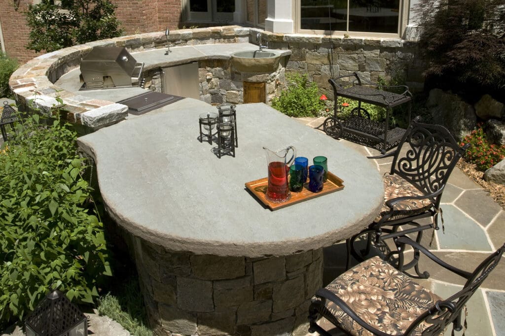 outdoor kitchen with massive stone slab countertop
