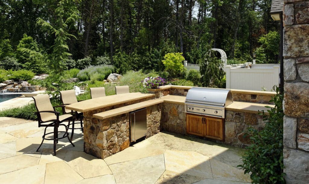 outdoor kitchen with split level stone bar top