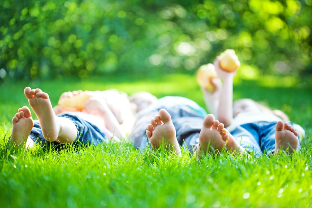 kids laying on lawn