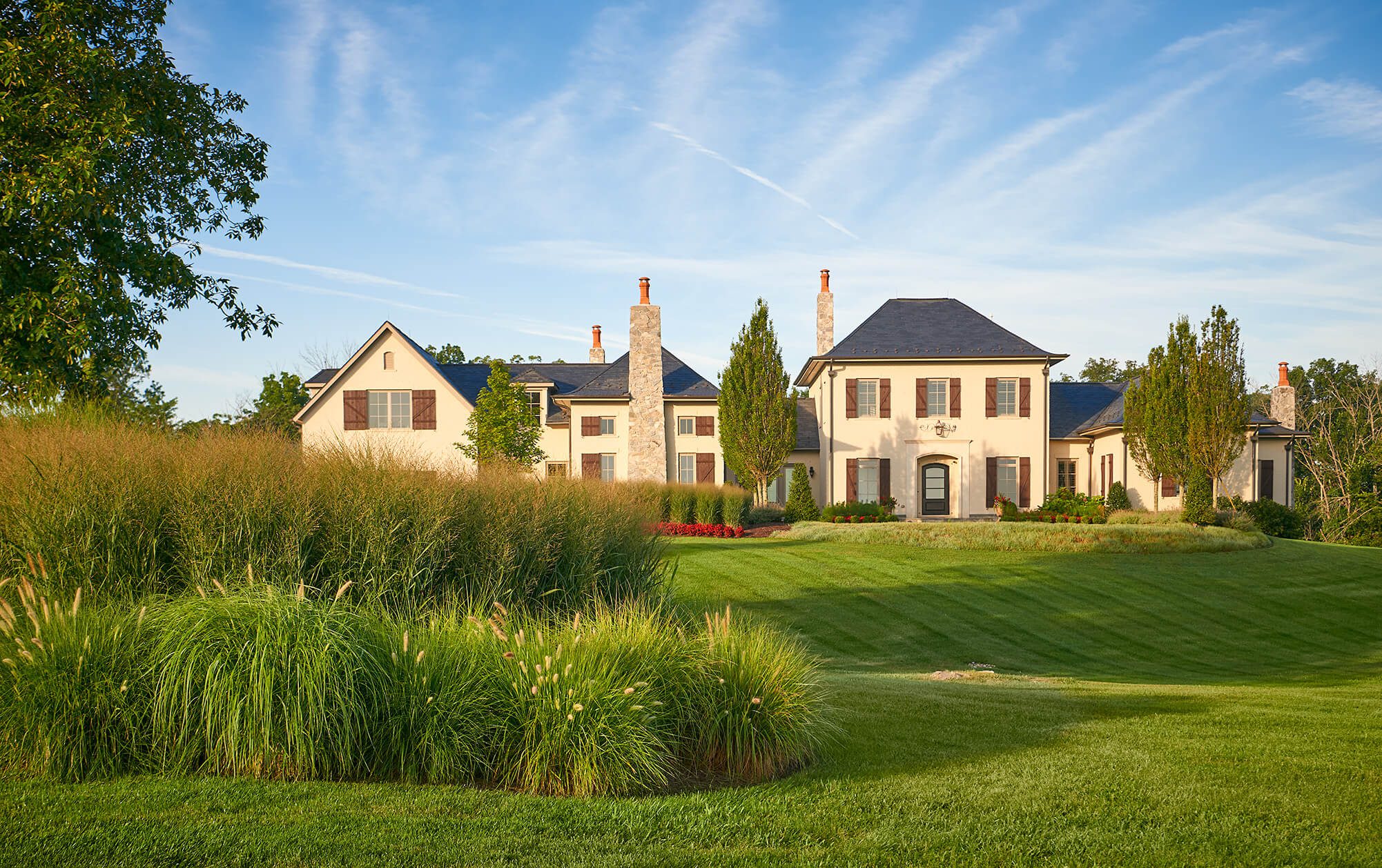 estate style grand front lawn and scultped landscaping