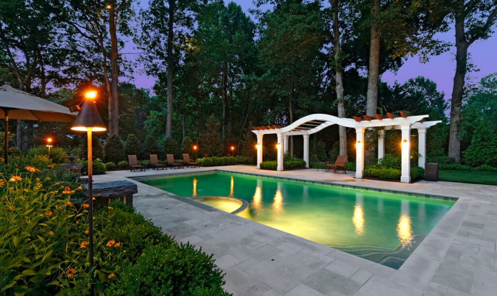 poolside pergola covering outdoor dining area