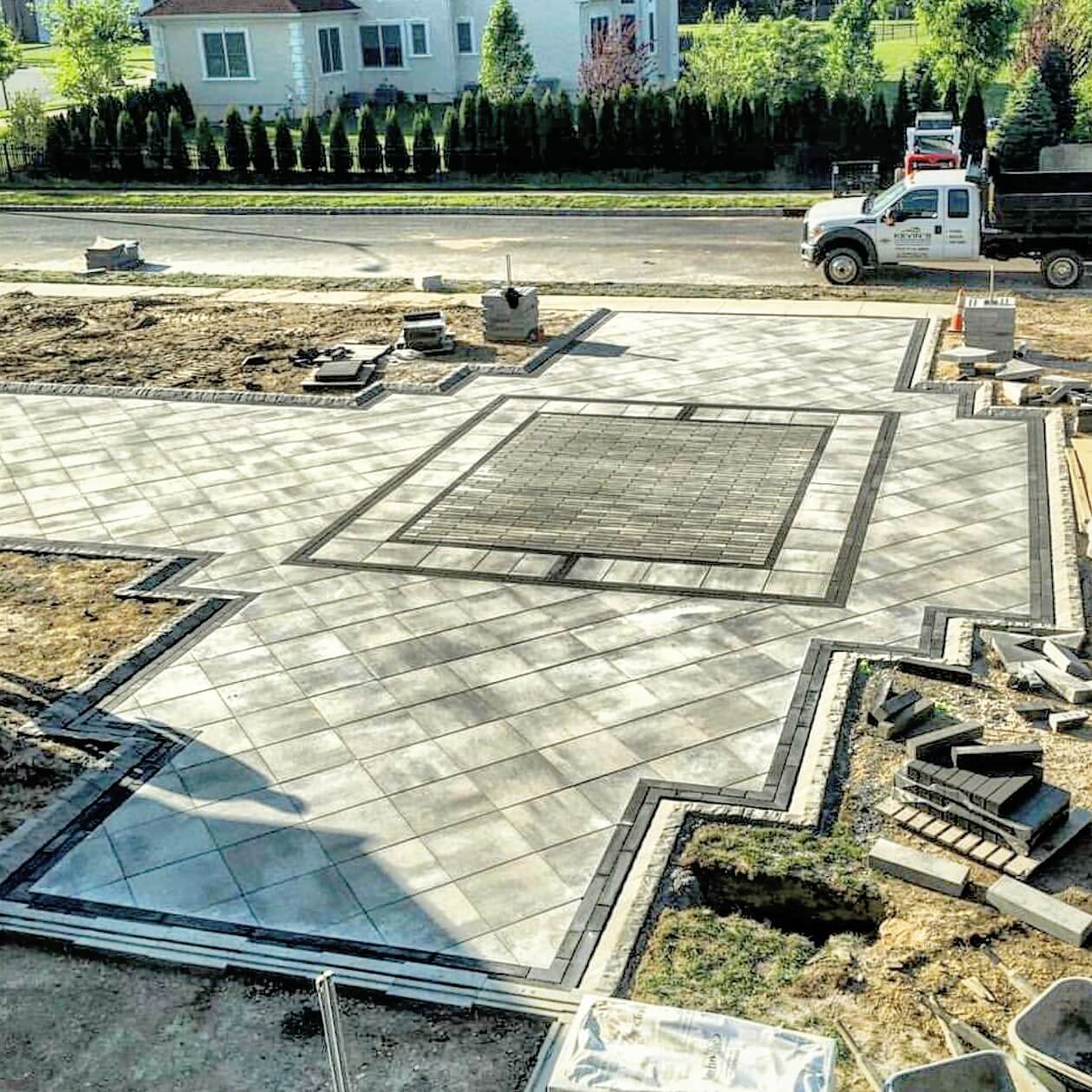 paver driveway with ornate inlay and border design