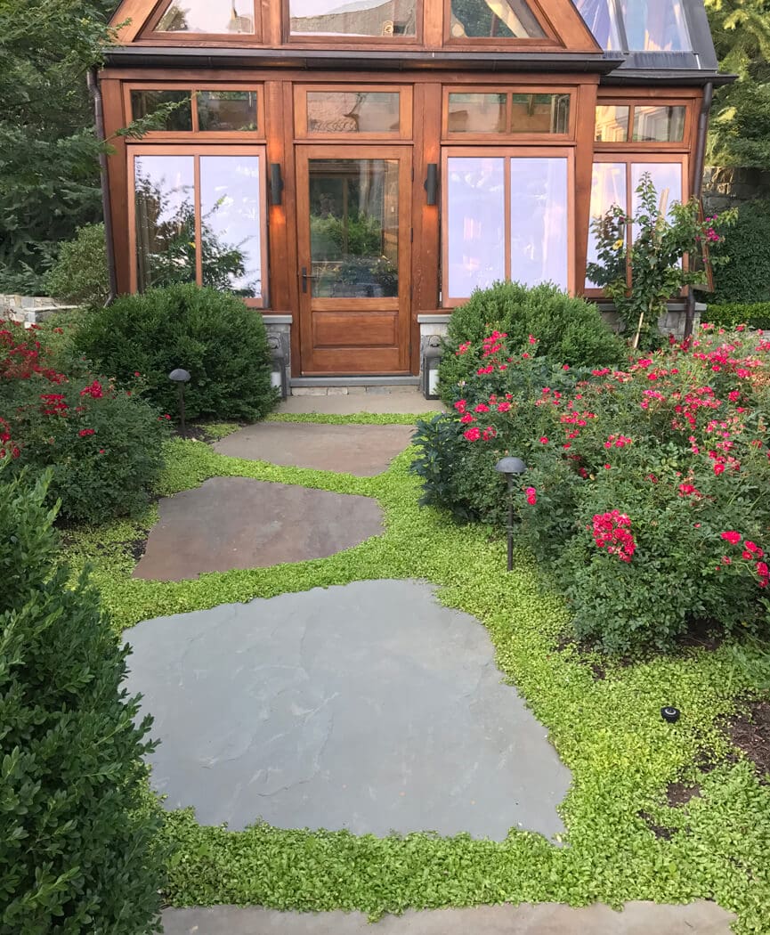 This walkway features irregular sized flagstone slabs with green joints