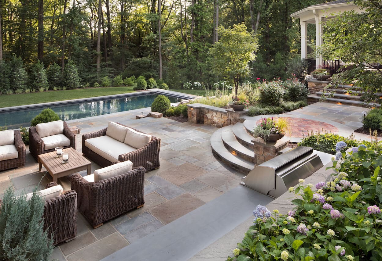 flagstone pool deck and raised patio with brick inlay
