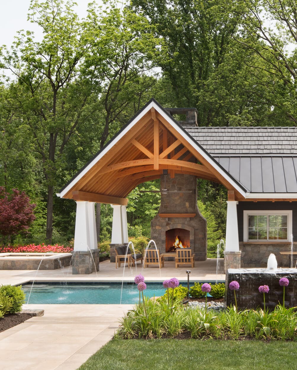 stone fireplace sheltered by poolside pavilion