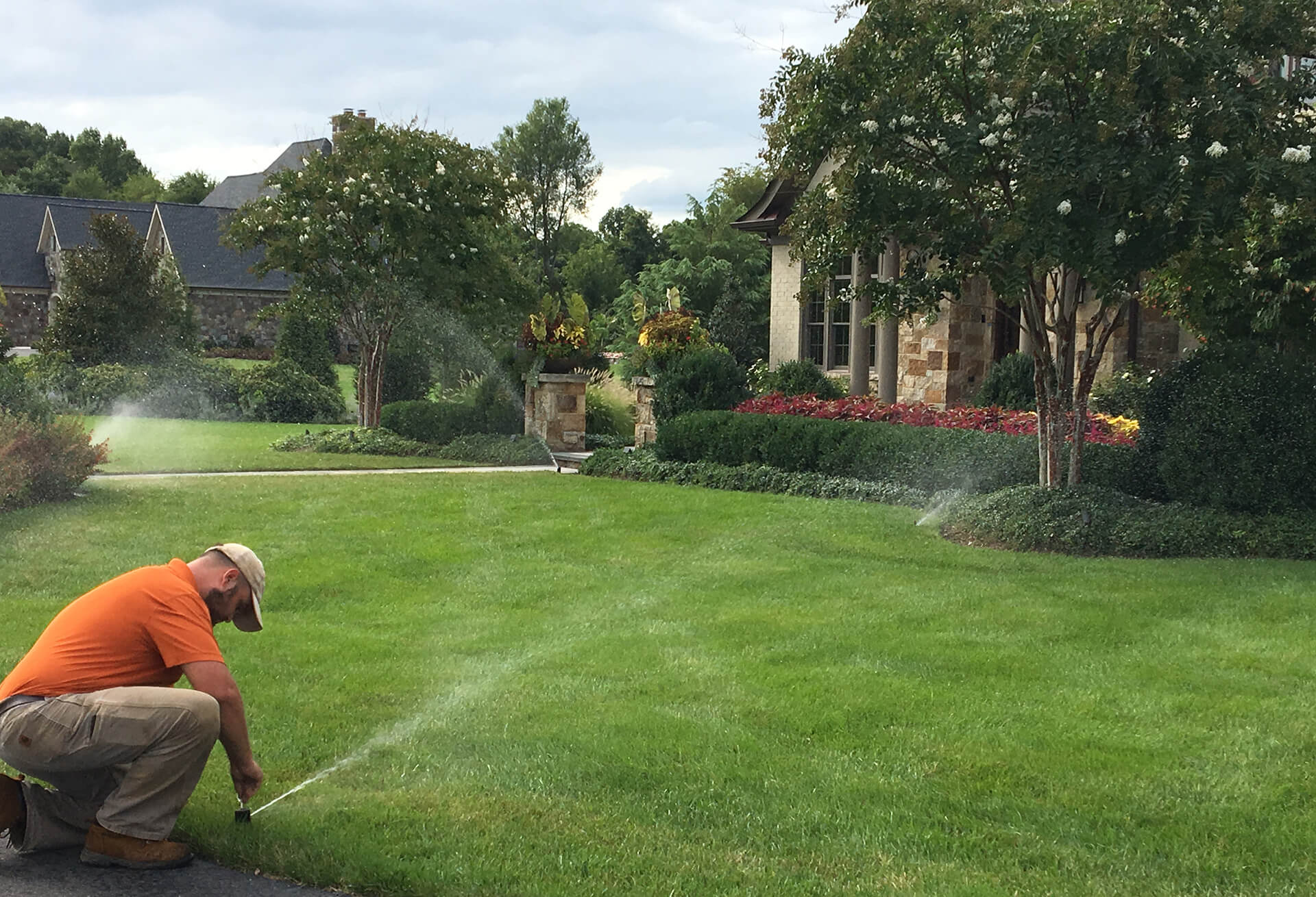 landscape irrigation technician adjusts the system