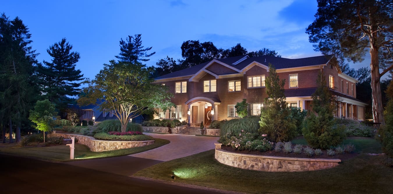 half moon driveway bordered by retaining walls & raised beds