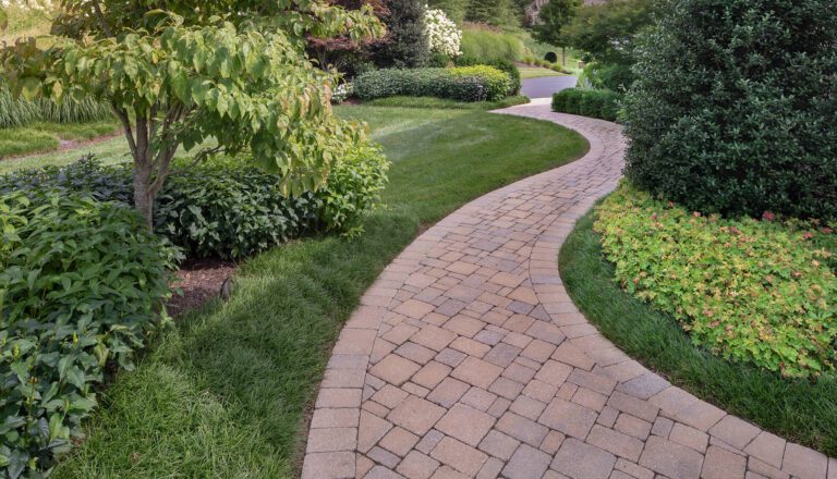a curving garden path of tumbled stone in varying size and shape