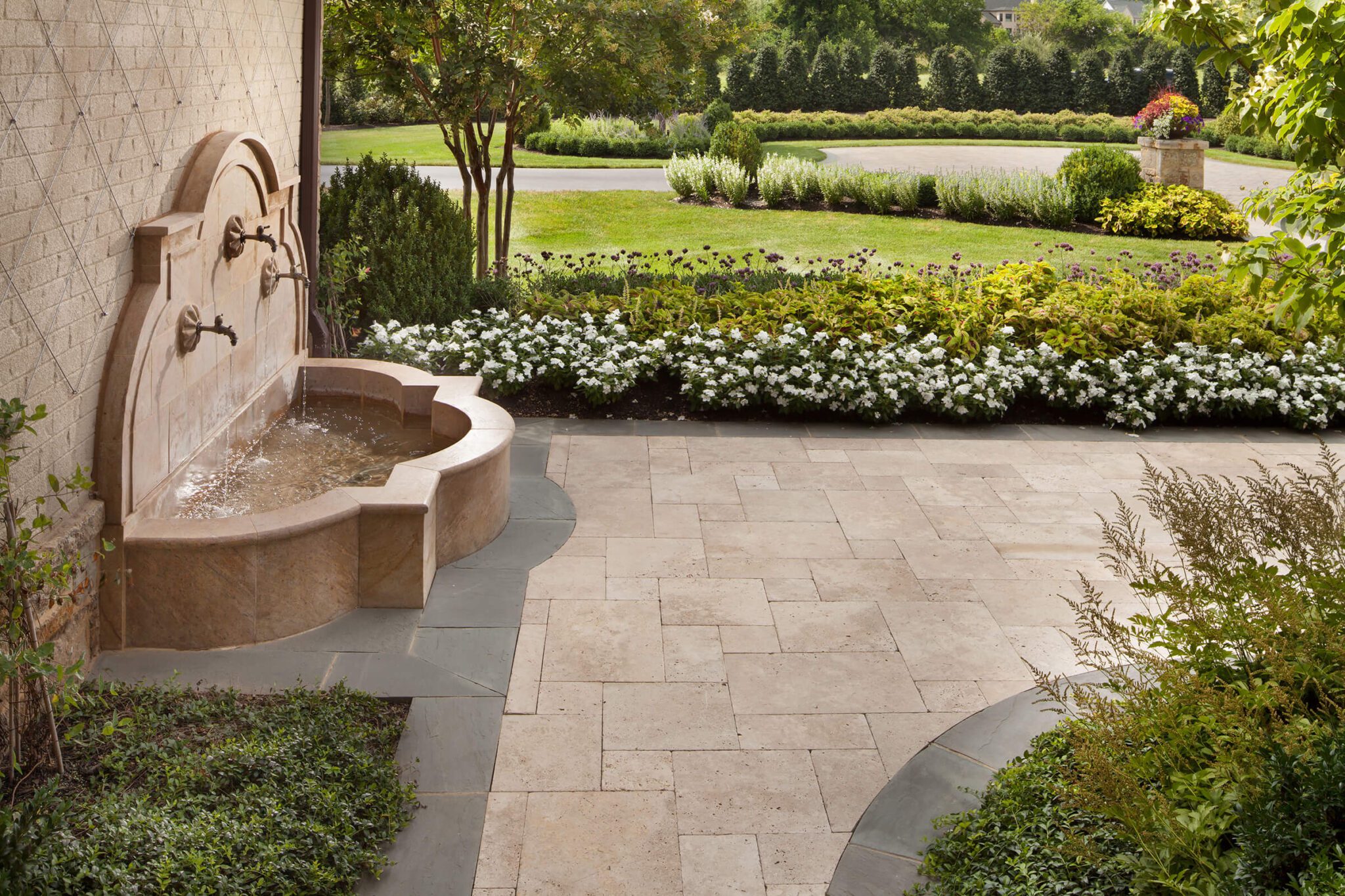 layered landscaping highlights a fountain and walkway in Vienna Virginia