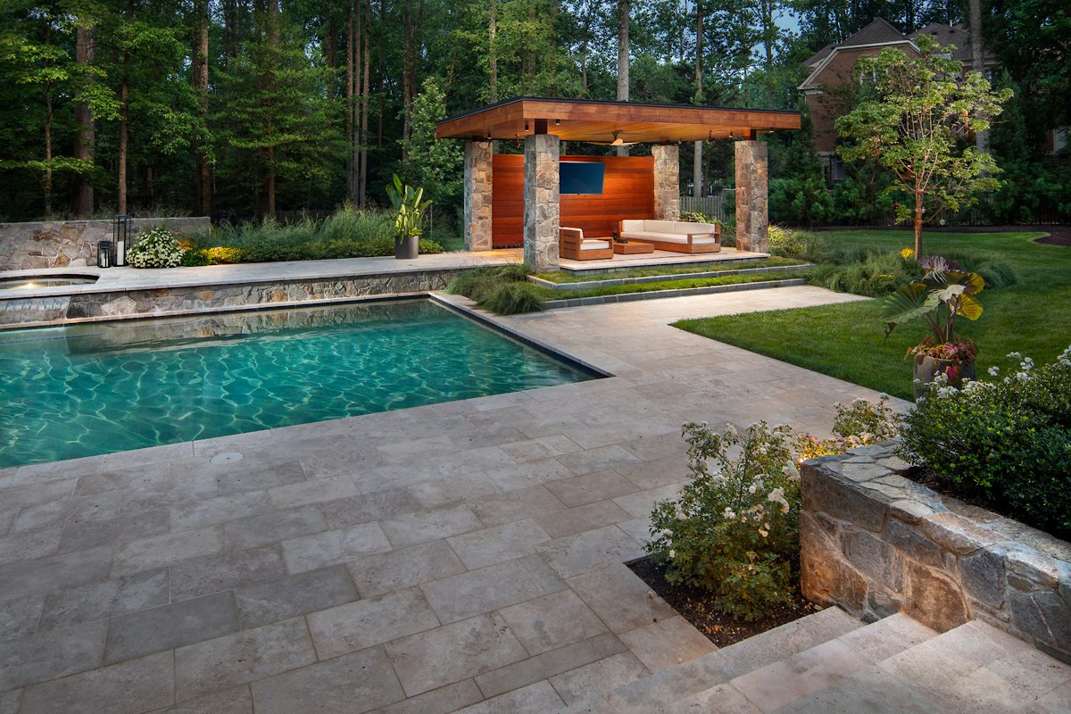 backyard pool with stone and cedar pool house