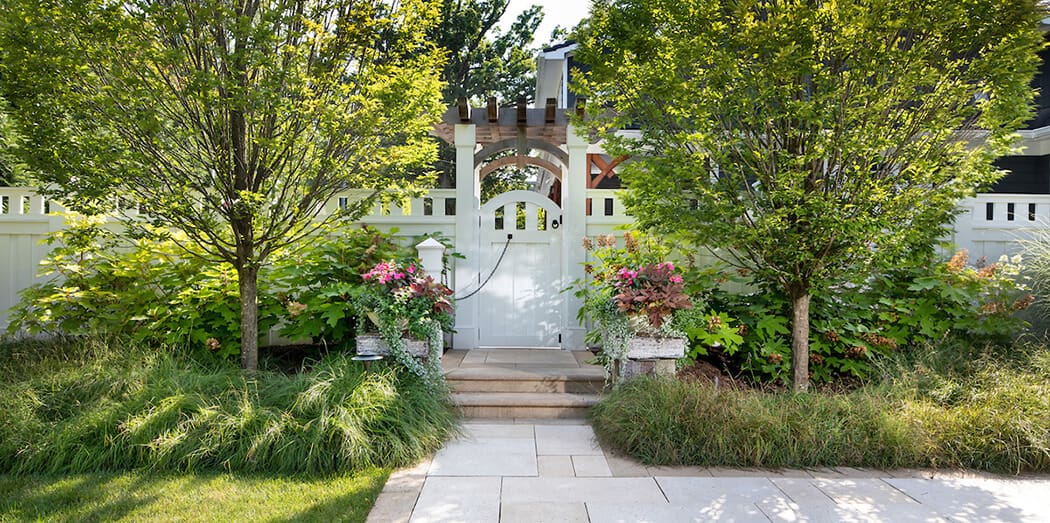 Garden gate and privacy wall of white painted wood