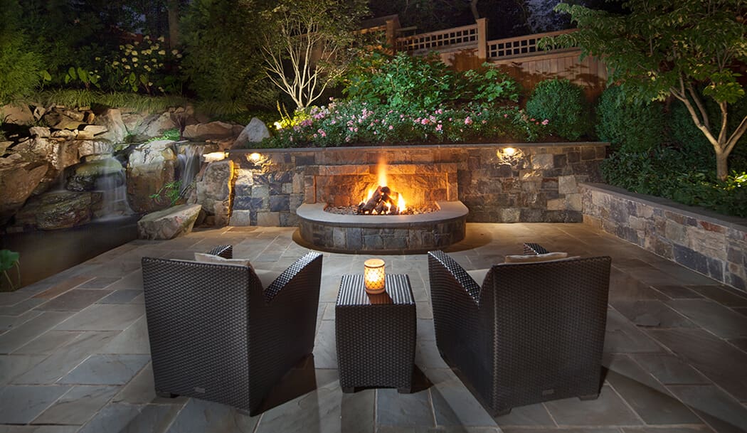 small yard firepit built into retaining wall