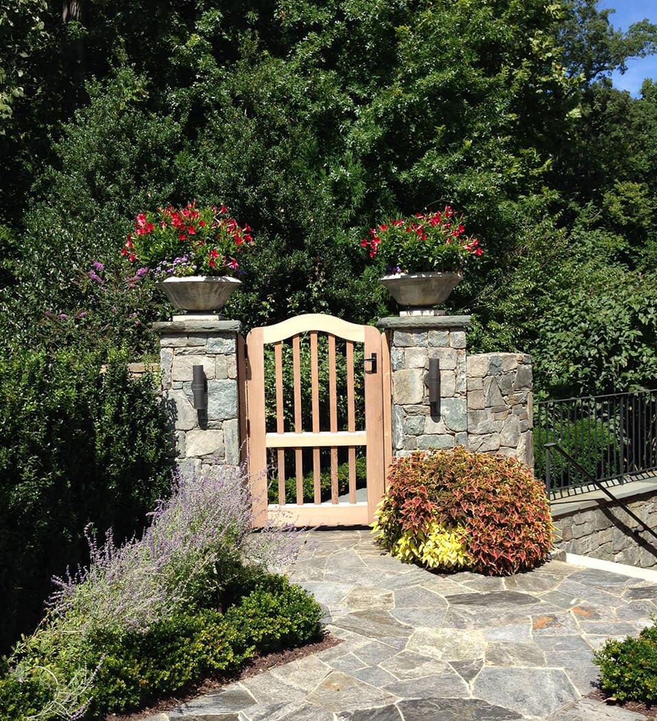 garden gate with summer with container displays of summer annuals