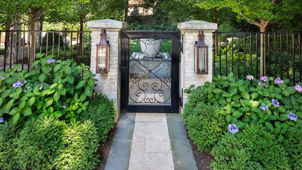 iron garden gate and stone pillars