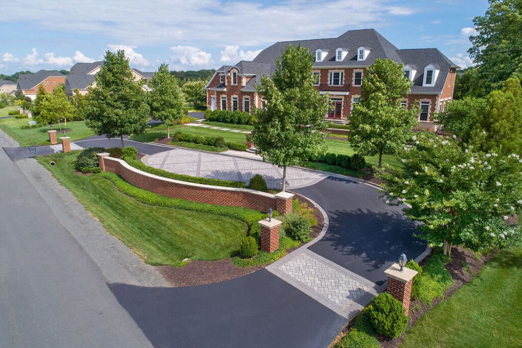 driveway surface design of asphalt + patterned pavers