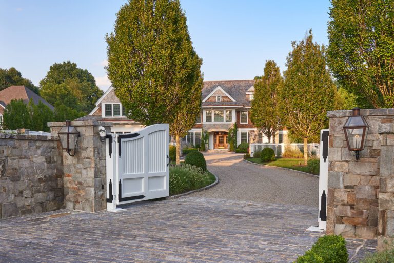 a gently curving driveway arrives at the front door of the home