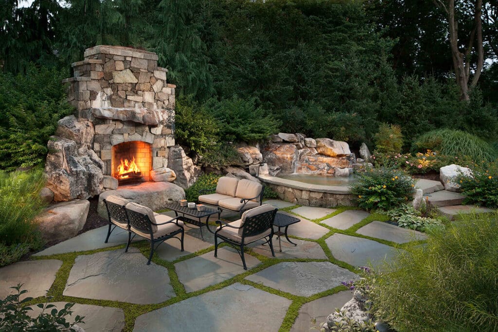 lush older landscape with stone patio