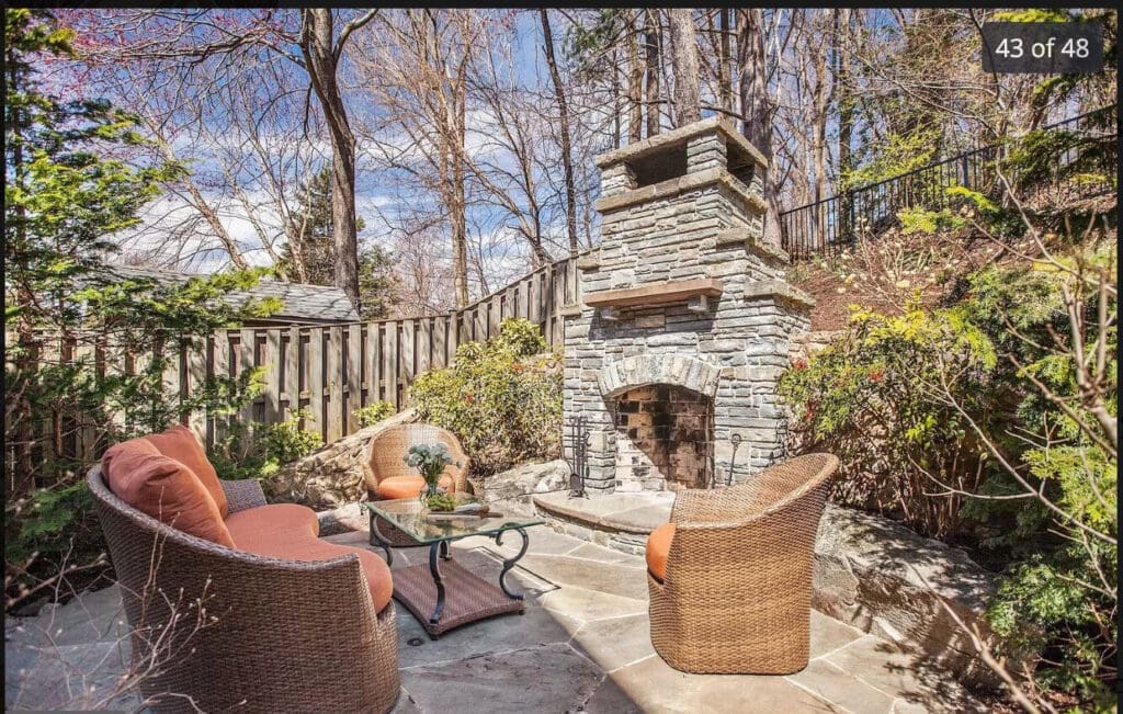 patio and outdoor fireplace against steep slope