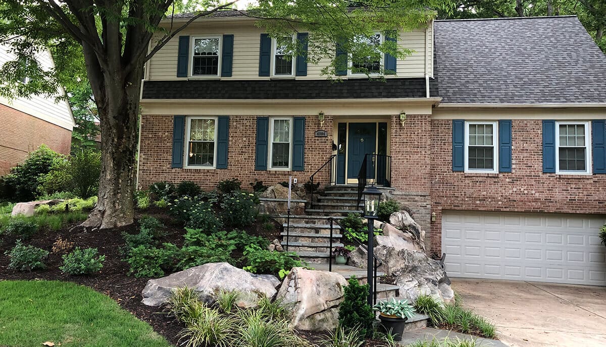 small front yard walkway with boulder retaining wall