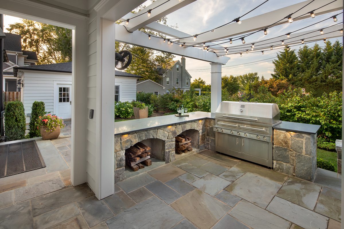 pergola with outdoor kitchen and bar seating