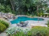 Clover leaf pool with boulders and lush plantings